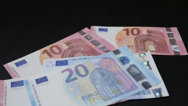 Counting-Euro-paper-money-different-values-in-slow-motion-1080p-HD-footage---Lot-of-European-Union-banknotes-falling-on-table-slow-mo-1920X1080-FullHD-video