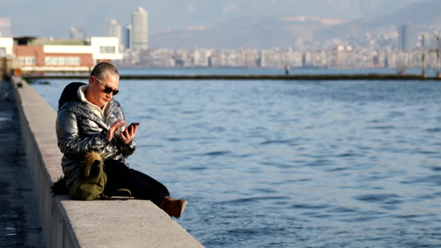 Middle-aged-woman-with-smartphone-at-the-outdoor