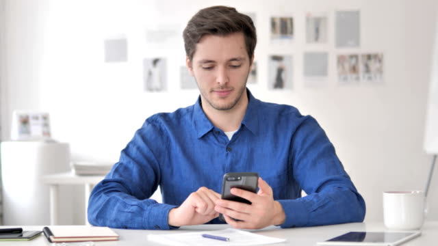 Casual-Adult-Man-Using-Smartphone,-Typing-Message
