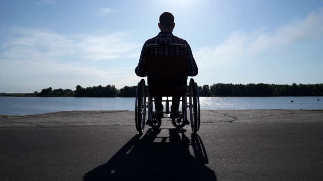 A-man-in-a-wheelchair-walks-on-the-waterfront