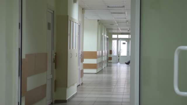 Empty-Corridor-with-Green-Doors-at-Hospital