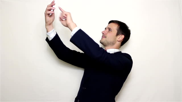 Young-handsome-businessman-making-selfie,-smiling-and-waving-his-hand.