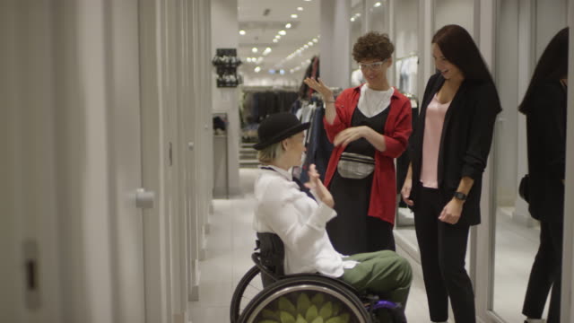 Woman-in-Wheelchair-Trying-on-Outfit-at-Clothing-Store