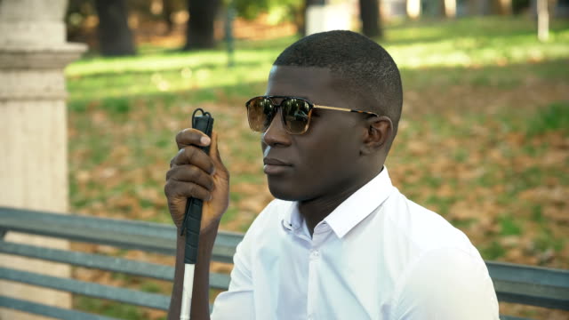 close-up-on-Blind-pensive-black-young-man-in-the-park.independence,-blindness,-autonomy