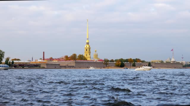 pleasure-ships-are-floating-near-Peter-and-Paul-Fortress,-waves-of-river-in-foreground