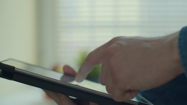 Man-using-tablet-computer-online-shopping-working-from-home.-Close-up.