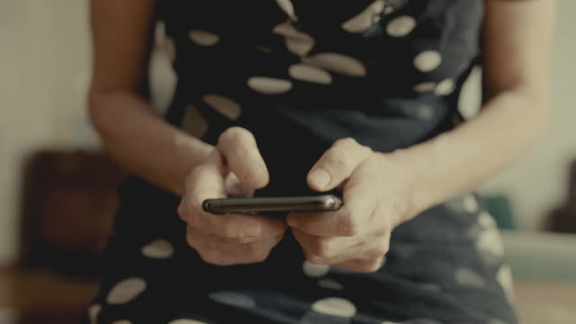 Woman-hand-using-mobile-phone