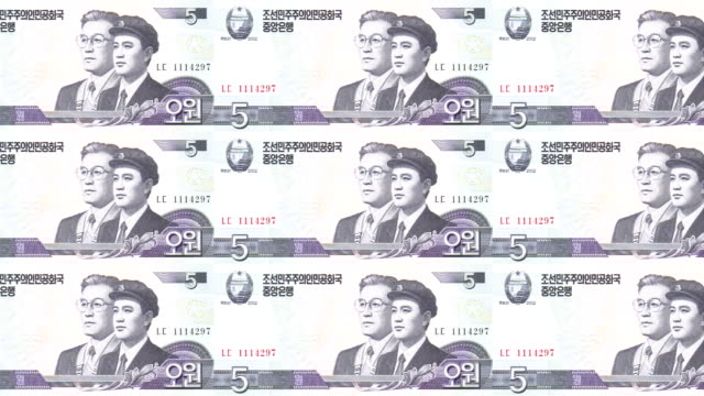 Banknotes-of-five-wons-of-North-Korea-rolling,-cash-money,-loop