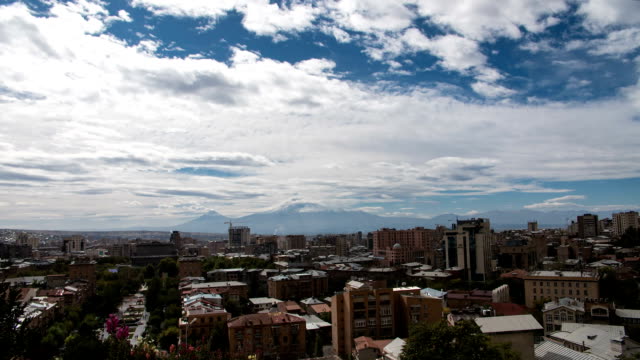 FullHD-Timelapse-of-clouds-above-the-city-with-huge-mountain-behind