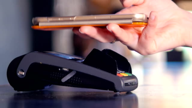 Wireless-payment.-Man-making-contactless-payment-with-smartphone.-4K.