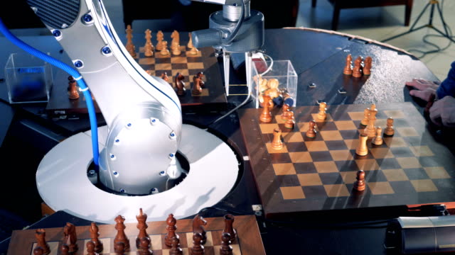Close-up-robot-chessplayer-playing-chess-with-a-himan.