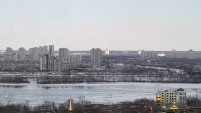 Kiev,-March-24,-2018,-Ukraine.-View-of-the-city-and-real-estate-through-the-winter-river-in-the-ice.