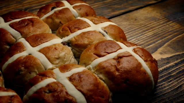 Passing-Hot-Cross-Buns-On-Wooden-Table