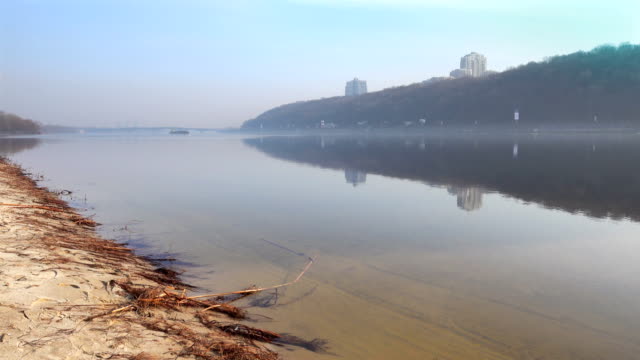 Blick-auf-dem-rechten-Ufer-des-Dnjepr-in-der-Nähe-von-Kiew.-Ruhige-Reflexion-in-den-Fluss-des-Himmels-und-Ufer.