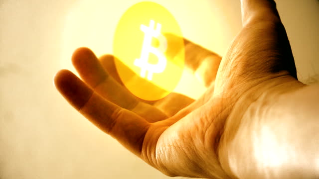 the-virtual-currency-of-a-bitcoin-in-the-hand-of-a-business-man