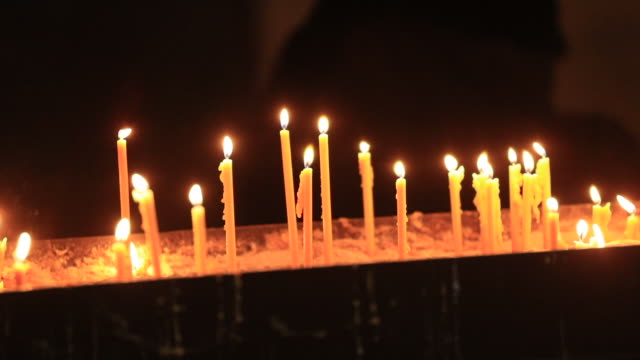 Burning-candles-inside-cathedral-church-for-prayer