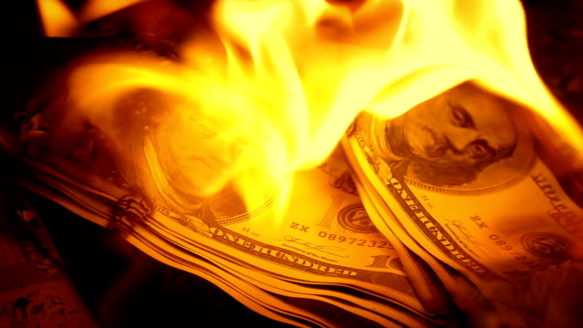 Hundred-Dollar-Bills-Put-On-Fire-Closeup