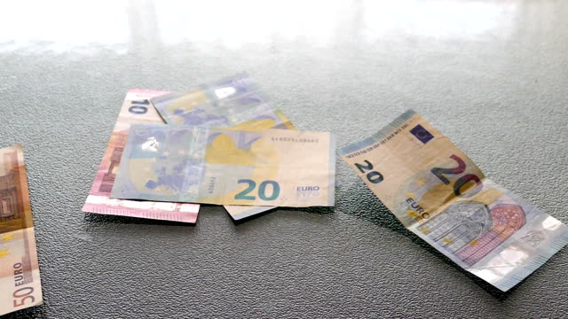 SLO-MO-euro-bills-falling-on-table