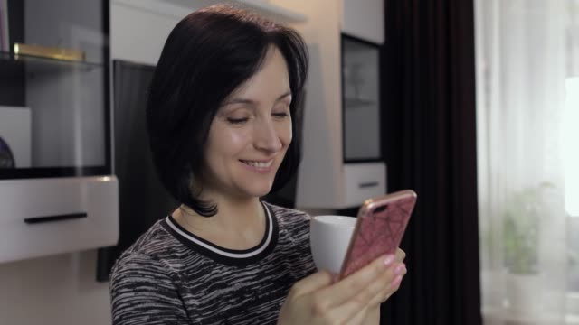 Woman-having-chat-on-social-media-using-smartphone-enjoying-chatting-to-friend