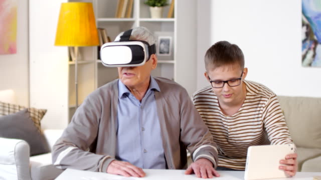 Boy-Showing-Virtual-Reality-to-His-Granddad