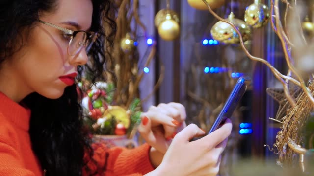 Girl-in-glasses-holding-smartphone
