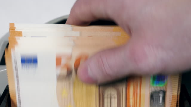 Billetes-de-cincuenta-euros-se-están-poniendo-en-la-máquina-y-contados
