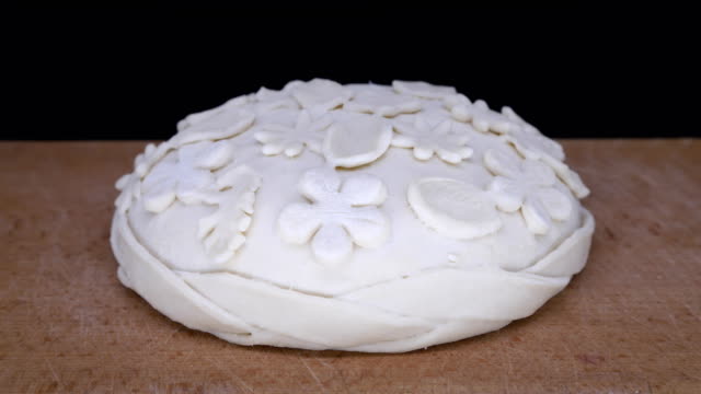 Pastry-time-lapse.-Yeast-dough-rising.-Decorated-dough.-Beautiful-easter-loaf-on-black-background.