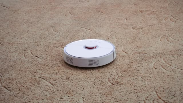 Close-up-shot.-Robotic-vacuum-cleaner-cleans-the-carpet-in-the-playroom