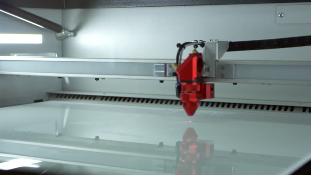 A-laser-cutter-in-operation-at-a-3D-printing-lab,-shot-on-R3D