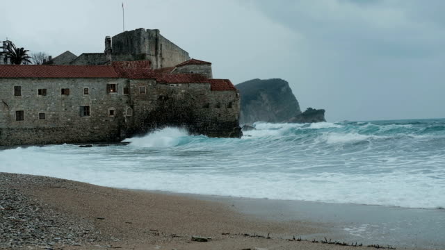 Gray-castle-washed-by-sea-waters-in-autumn-day
