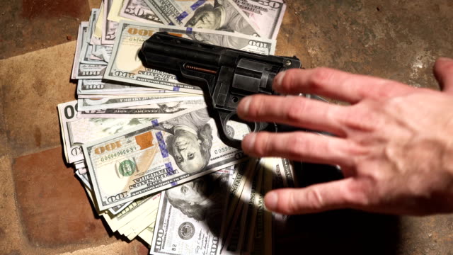 money-and-a-revolver-.-Criminal-concept
