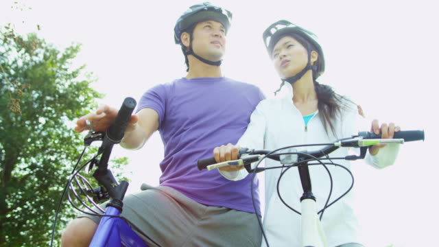 Pareja-hombre-mujer-asiática-China-ejercicios-bicicletas-juntos