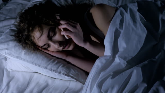 Female-Lying-in-Bed-at-Night-Talking-on-Mobile-Phone,-Call