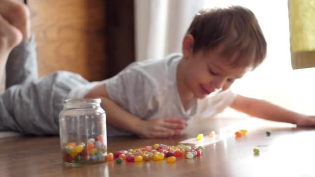 cute-boy-playing-with-colorful-candies