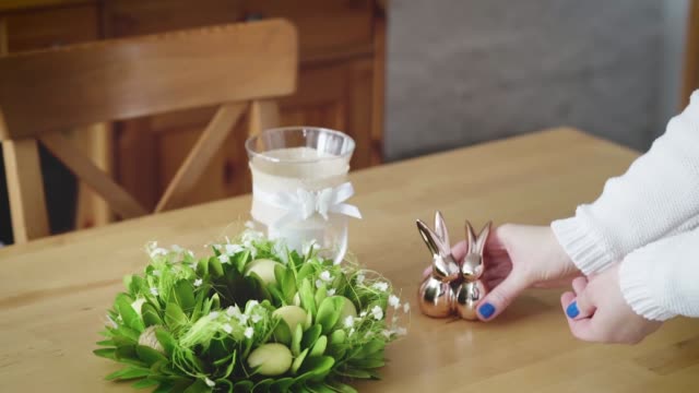 woman-arranges-beautiful-Easter-decorations-on-the-table
