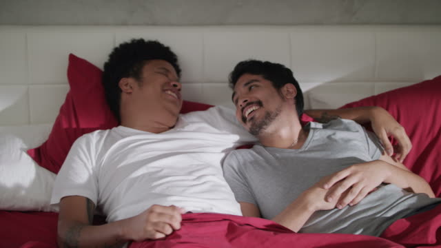 Junge-schwule-Männer-lachen-und-entspannen-im-Bett-zu-Hause
