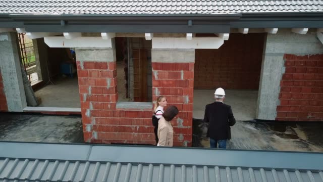 Construction-Site-With-Architect-And-Women-Buying-New-House