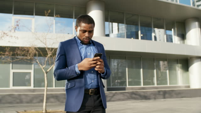 African-Businessman-Chatting-on-Cellphone-Outdoors