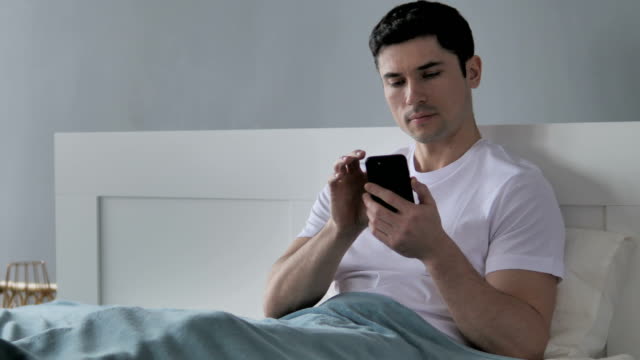 Young-Man-Browsing-Smartphone,-Using-Internet
