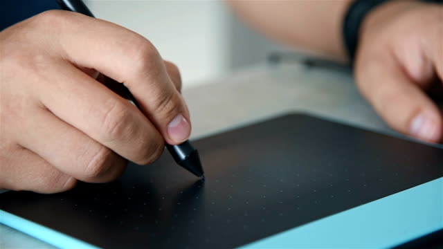 Close-Up-Of-Male-Hands-Using-Graphic-Tablet