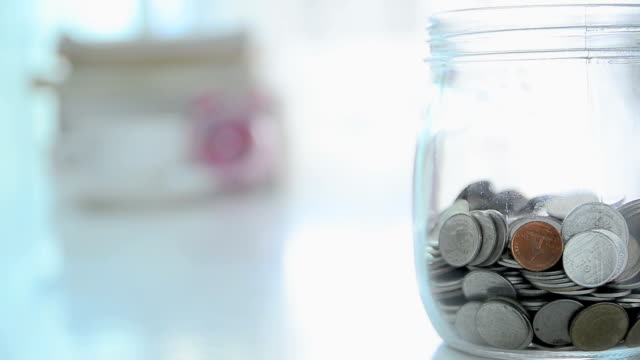Falling-of-coins-to-glass-jar-concept-to-saving-money