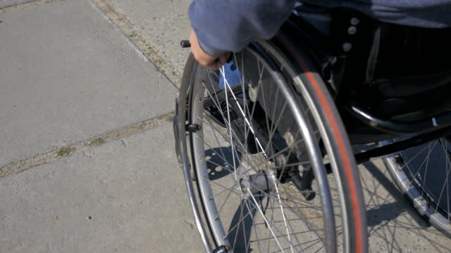Wheelchair-wheels,-Difficulty-traveling-wheel-chair-on-street,-Disabled-man-in-wheelchair,-movement-people-with-disabilities