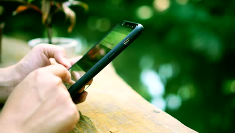 Woman-hand-using-smartphone-in--cafe-background.-Business,-financial,-trade-stock-maket-and-social-network-concept.