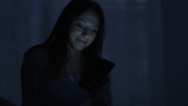 Woman-chatting-with-her-phone-late-at-night