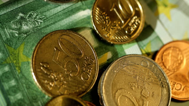 Close-up-shot-of-Euro-money,-coins-and-banknotes.-Euro-currency.-Coins-stacked-on-each-other-in-different-positions.-Money-concept.-Rotation