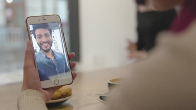 Video-Call.-Close-Up-Hand-With-Video-Chat-On-Mobile-Phone-Screen
