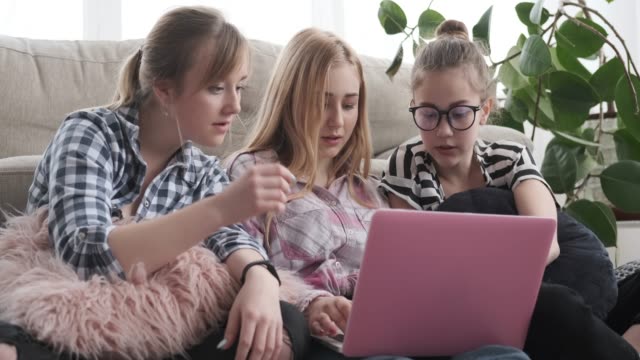 Teen-girls-watching-media-content-on-laptop