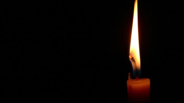 Simple-burning-candle-close-up-on-a-black-background.-Quickly-timelapse-full-HD-1920-X-1080.