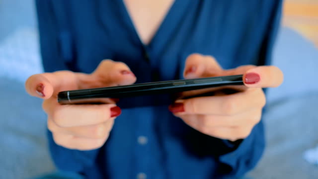 Woman-playing-with-smart-phone