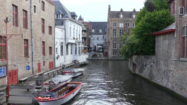 Bruges,-Belgium---May-2019:-View-of-the-water-channel-in-the-city-center.-Boat-trip-along-the-water-canals-of-the-city.